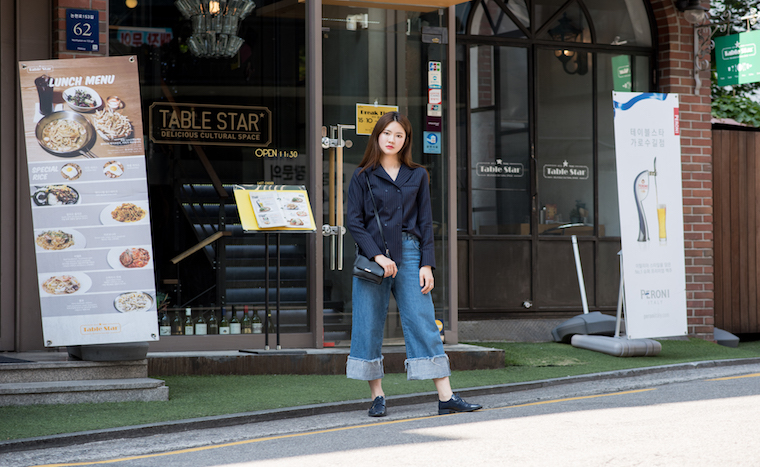 24 year old model Jung So Hee wearing a navy blue double breasted blouse with denim pants and black oxfords.