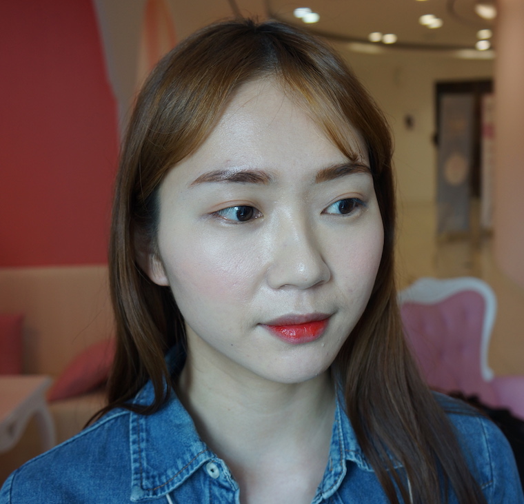 Charlotte Cho wearing a cheery red lipstick experimenting with brown eyebrow tint from Etude House