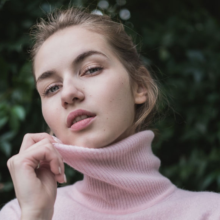 portrait of a young beautiful cute girl in a sweater close-up